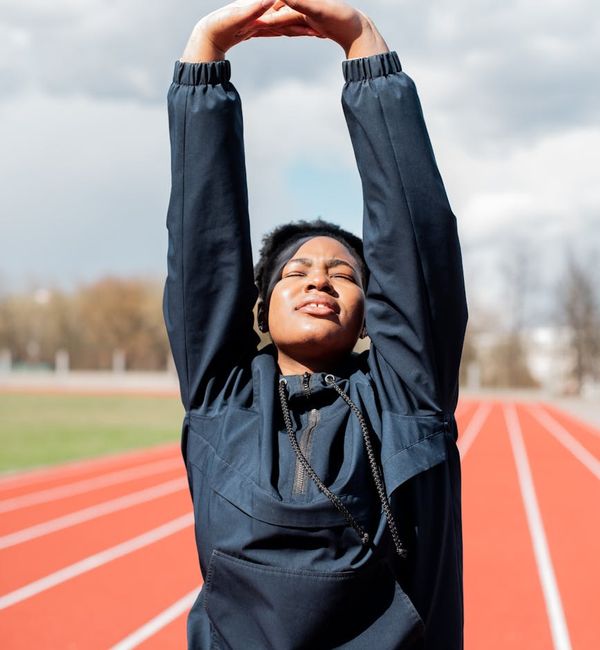 Person feeling energized and stretching towards the sky.